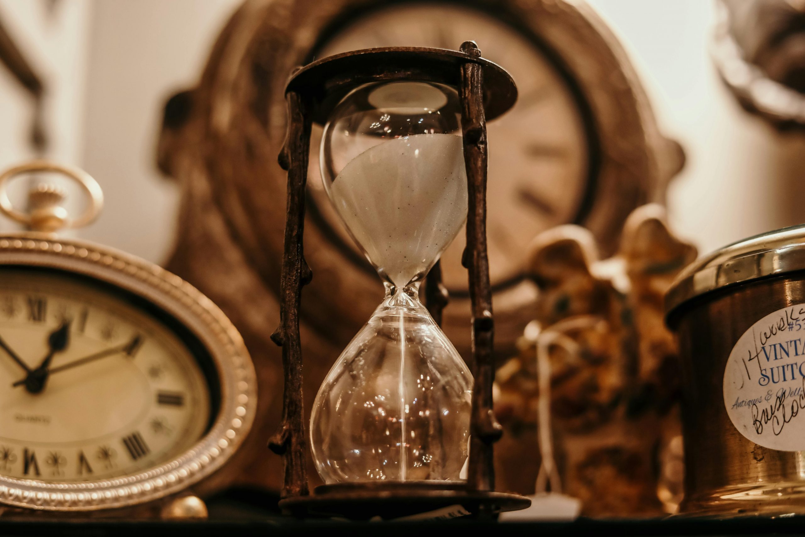 hour glass and clocks in a sepia tone
